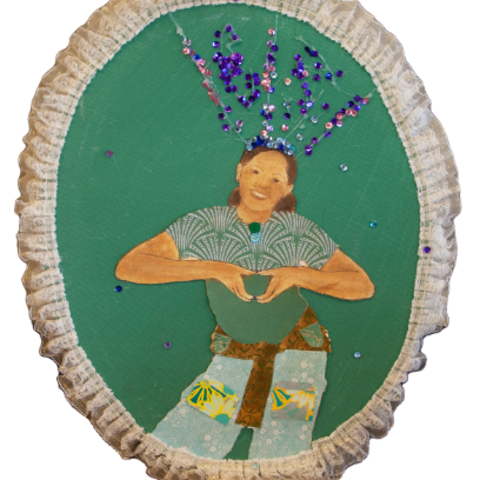 Self-portrait of a young girl with a sparkly bow, making heart shape with her hands