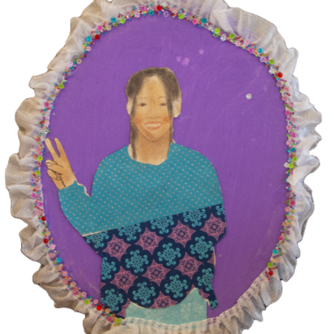 Self-portrait of a young girl wearing a blue sweater with decorative detail
