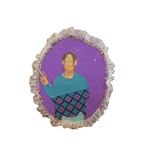 Self-portrait of a young girl wearing a blue sweater with decorative detail